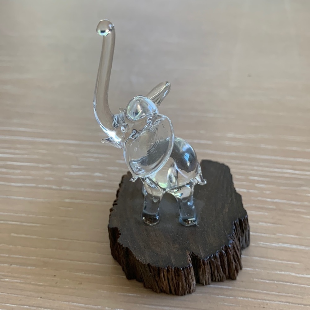 Adorable little glass elephant on a piece of wood- must have very skilled hands!